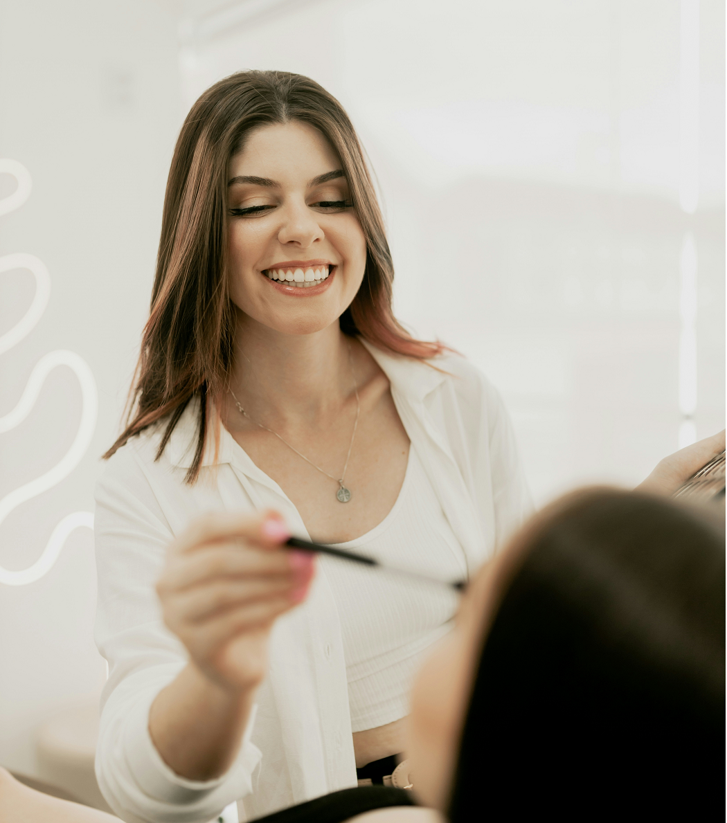 Salon owner with makeup brush